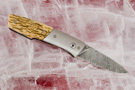 Custom folding knife with Damascus blade